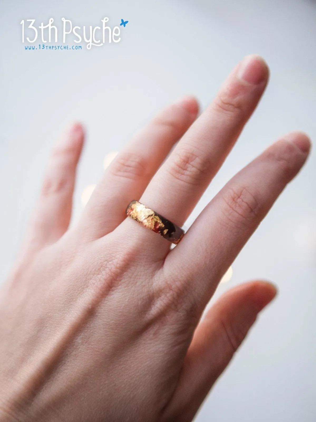 Black and red faceted resin ring with gold flakes