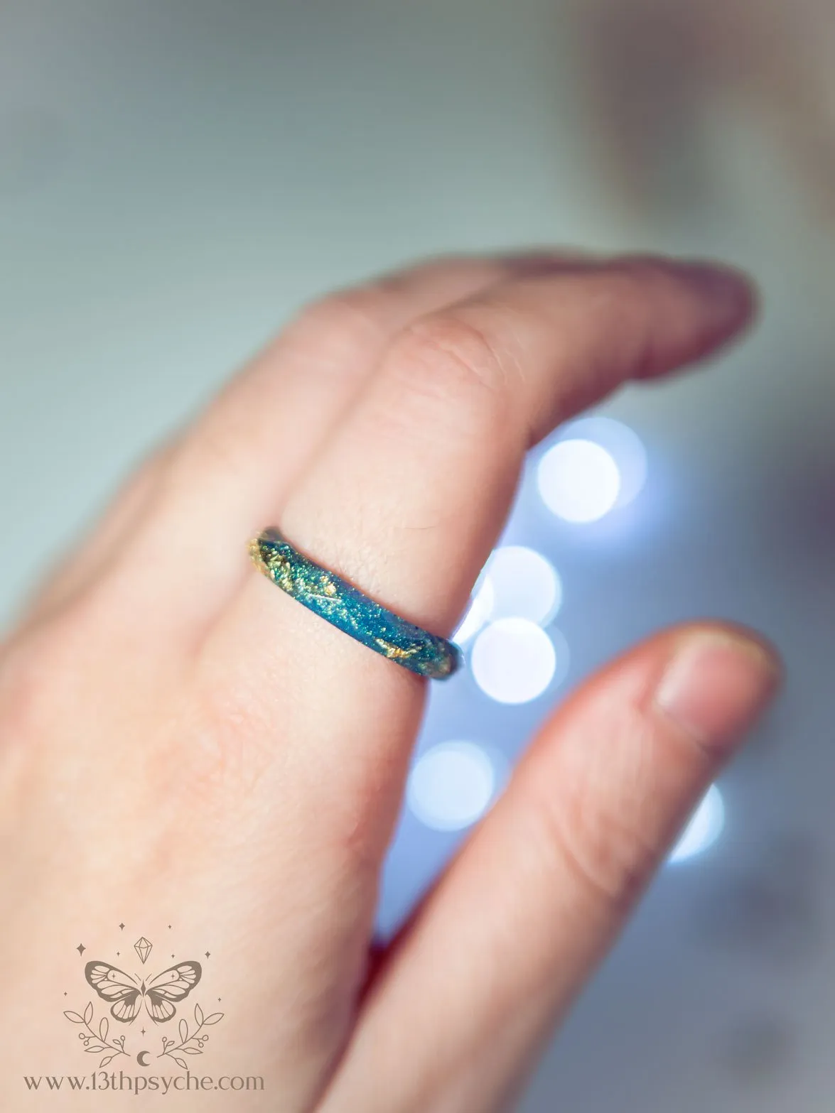 Iridescent blue faceted resin ring with gold metal flakes