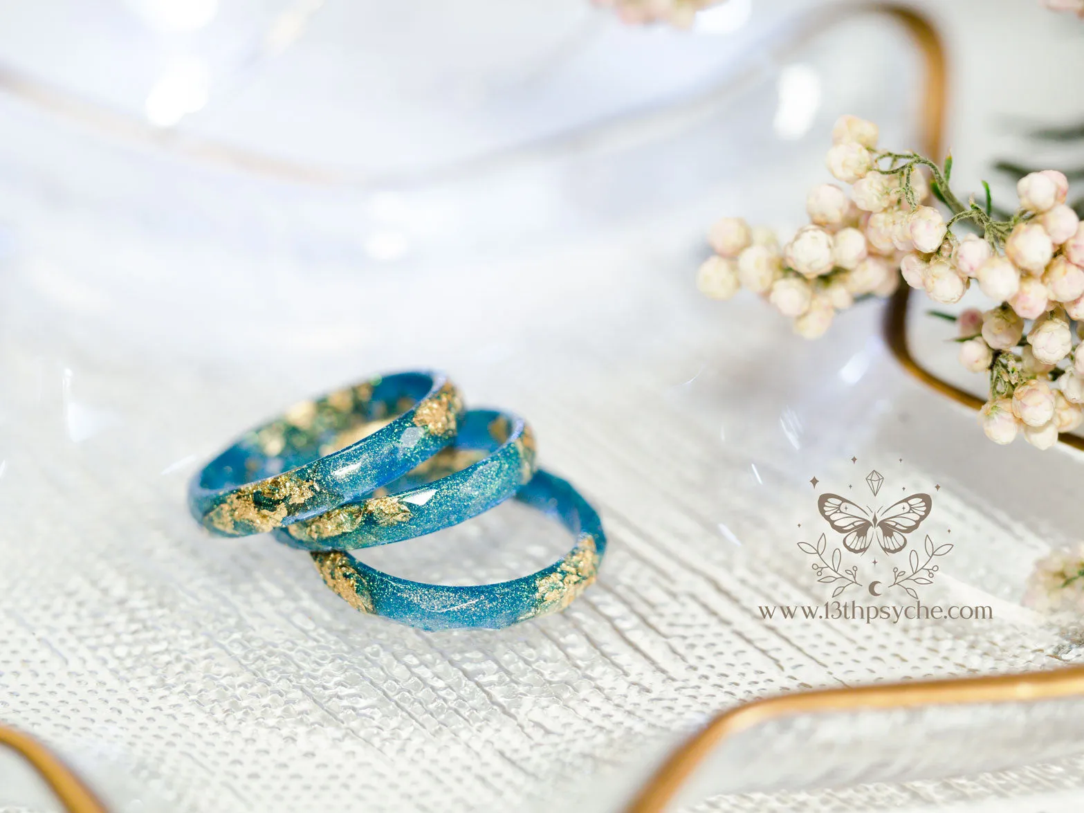 Iridescent blue faceted resin ring with gold metal flakes