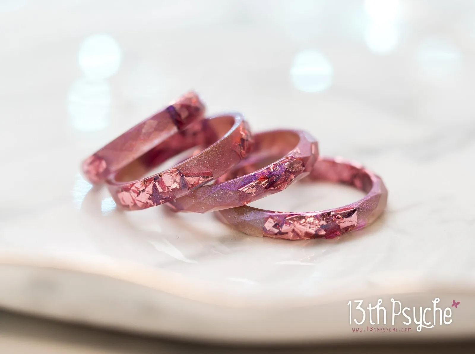 Iridescent pink faceted resin ring with pink metal flakes